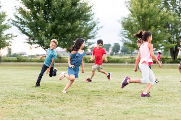 Children running outside in a park