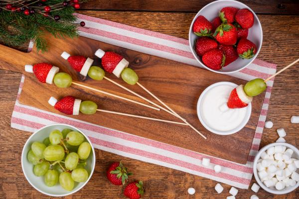 grinch hats on skewers made with green grapes, strawberries and mini marshmallows
