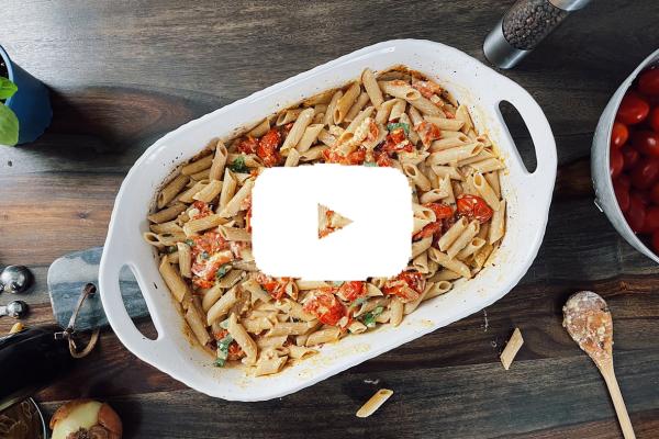 Pasta with roasted tomatoes and feta in a baking dish