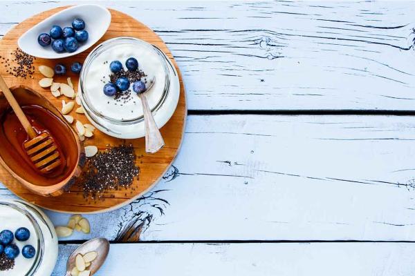 Jars of yogurt with blueberries and honey