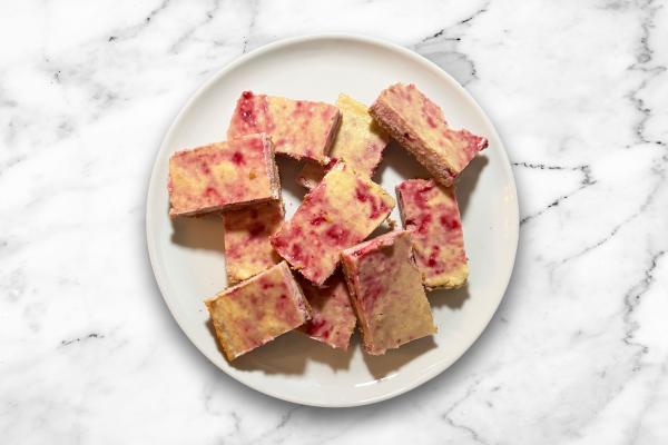 Spiced Eggnog Cheesecake Bars with a Cranberry Swirl