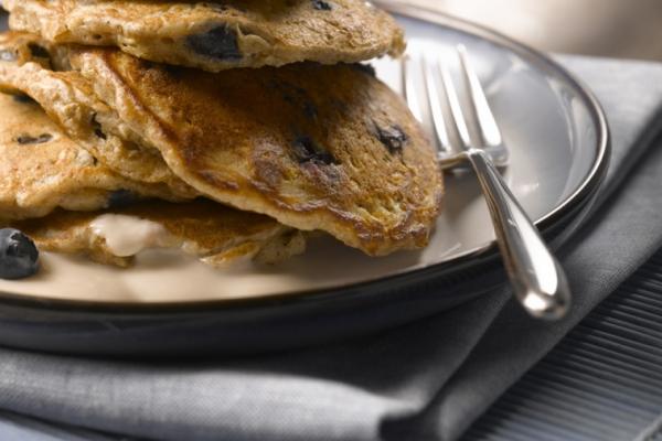 blueberry and oatmeal pancakes with maple yogurt topping