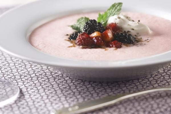 chilled strawberry soup with drunken berries and peppered whipped cream