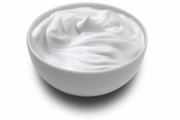 A bowl of freshly made crème fraîche on a white background, indicative of a simple yet versatile creme fraiche recipe