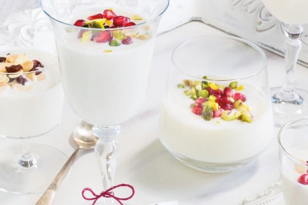 Three milk puddings topped with berries and nuts