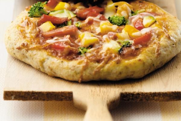 Pizza served on a wooden pizza wheel