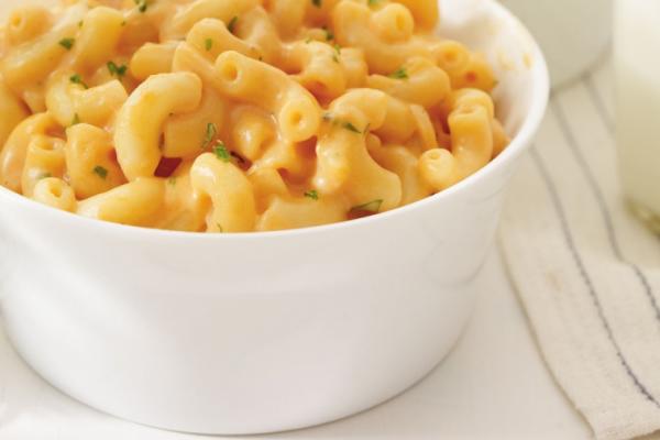 Bowl of macaroni and cheese with tomato sauce