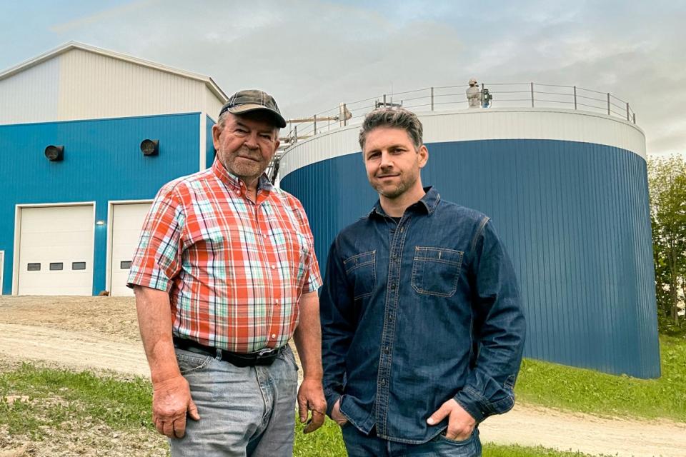 Farmers in front of a biodigester