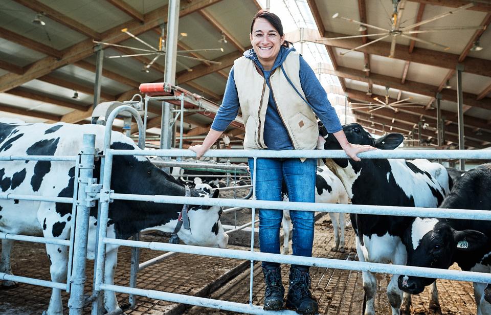 A dairy farmer with her cows in Canada