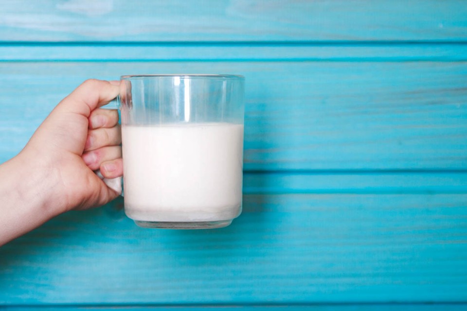 Glass on milk on wooden table