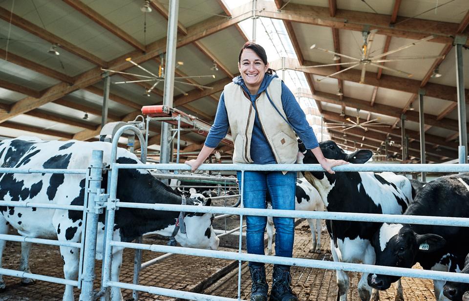 Ana-Maria in front of her dairy cows