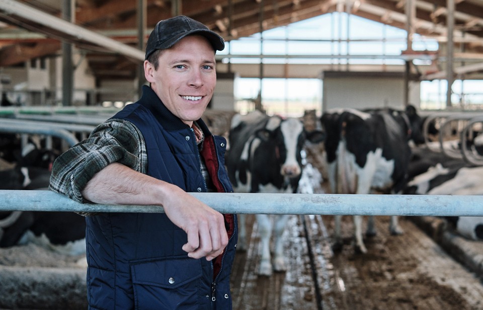 Nicolas in front of his dairy cows