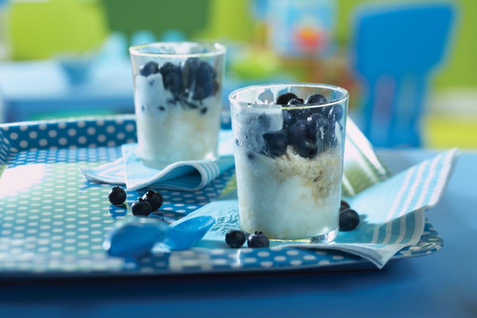 Blueberry parfait made with yogurt, oats and blueberries in small glasses on a tray