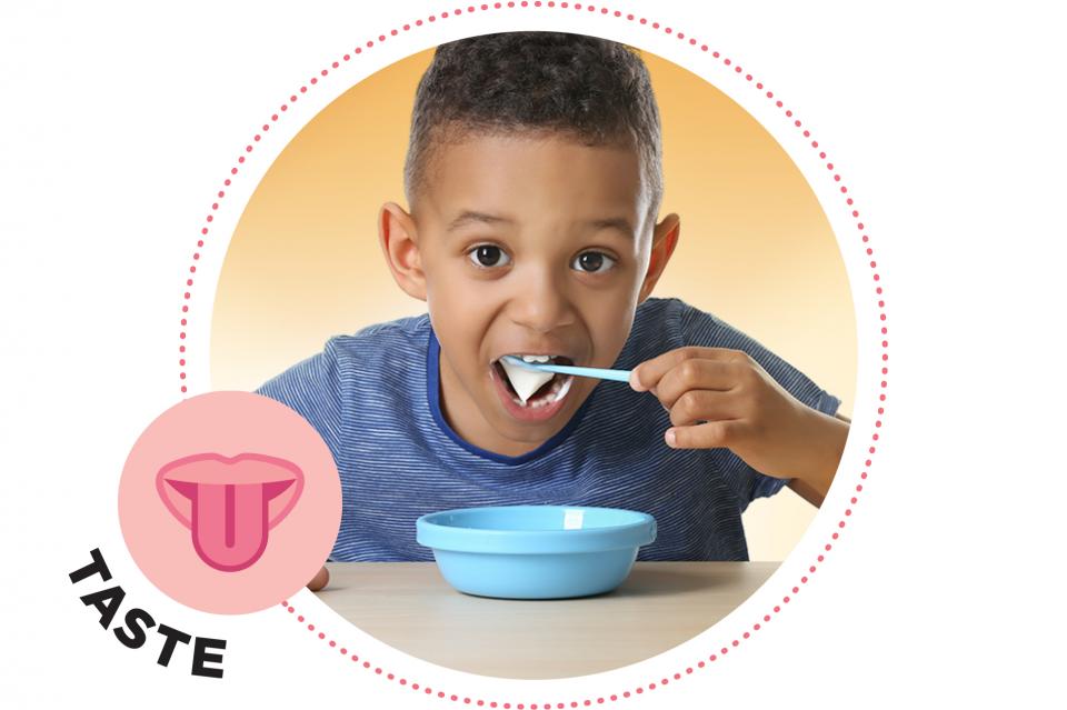 Little boy eating a bowl of yogurt.