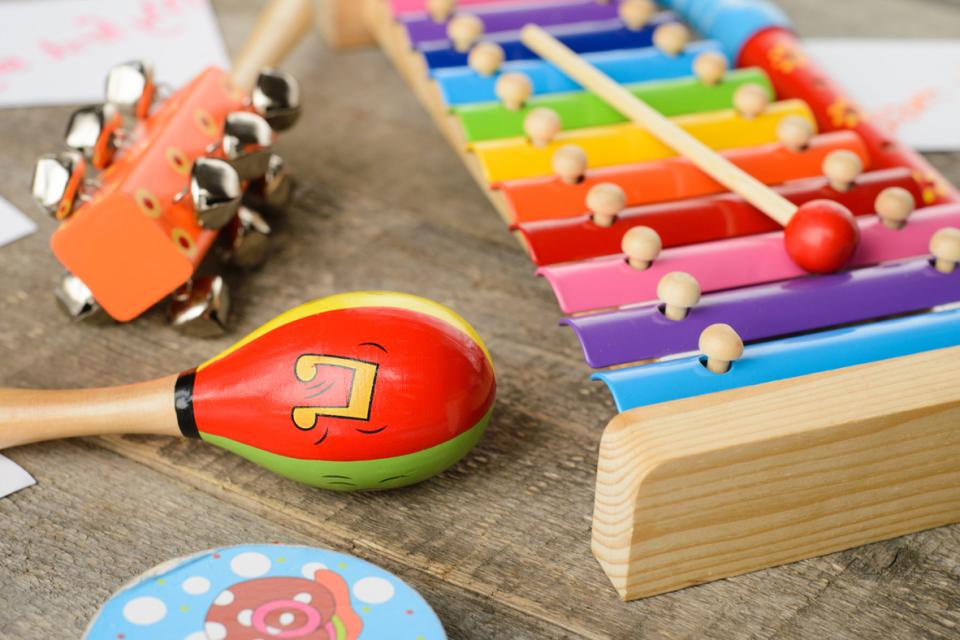 Musical instruments for children on a wooden background.