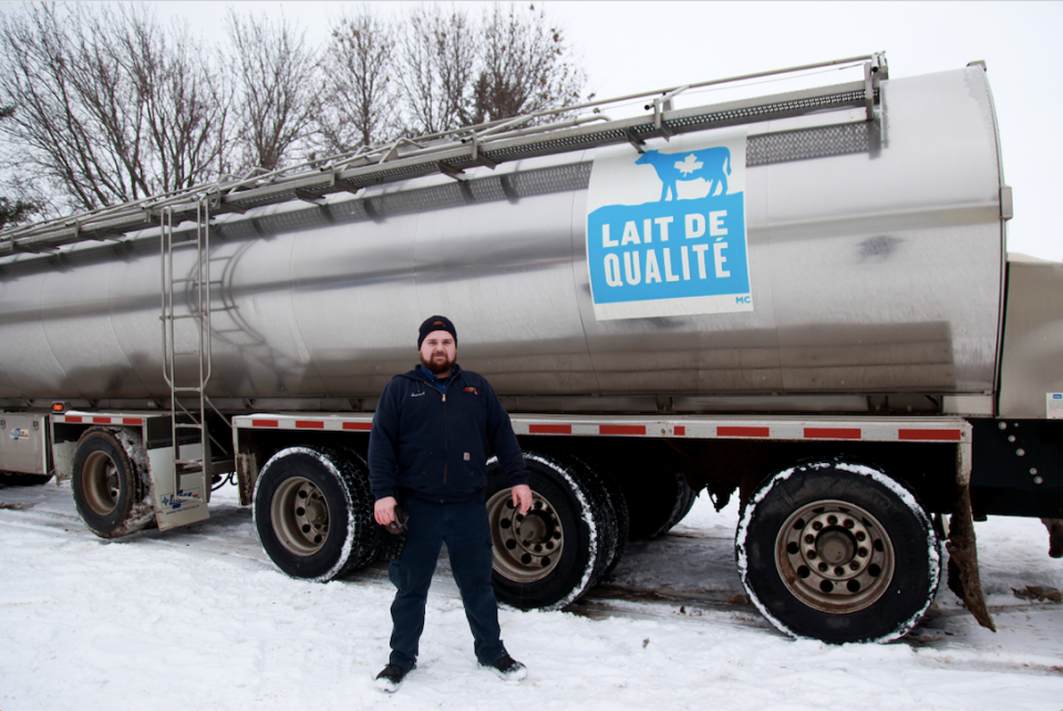 A milk truck driver in front of his DFC truck