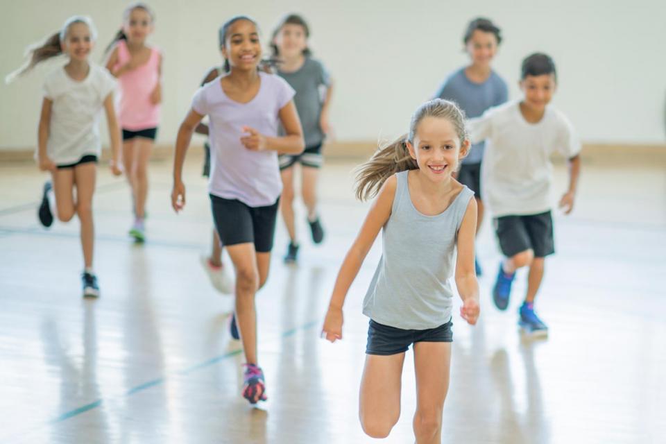 Students running in a gym
