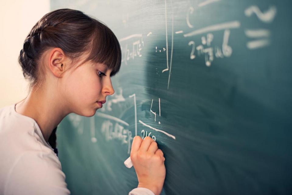 Young girl solving a mathematical problem
