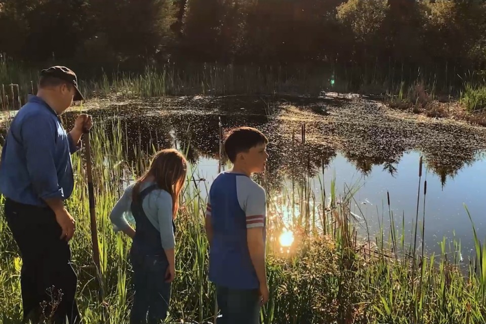 Farmer and family near wetlands