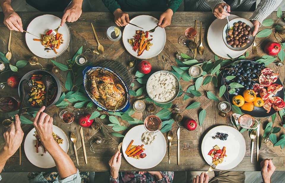 Friends and family gathered around a table sharing a meal