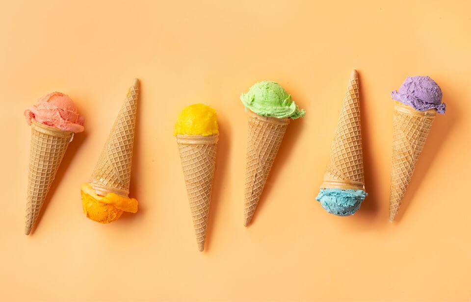 Various ice cream cones on a yellow background