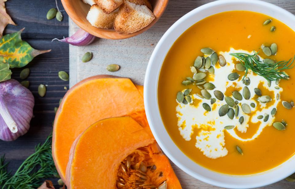 Pumpkin soup drizzled with cream