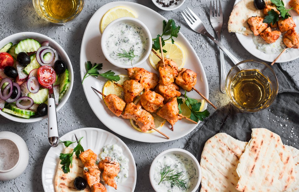 Yogurt marinated grilled chicken souvlaki with tzatziki on the side.