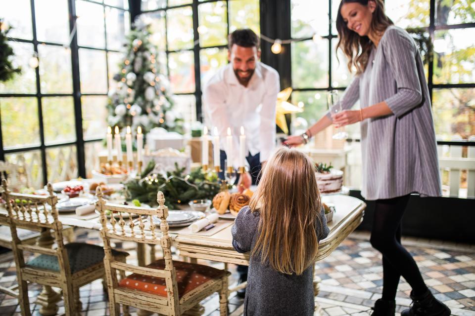 A family sets the table for holiday dinner