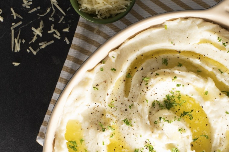 Bowl of creamy Cheesy Mashed Potatoes with Canadian cheddar