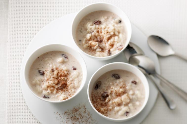 Three bowls of creamy rice pudding sprinkled with cinnamon, showcasing a delightful homemade recipe