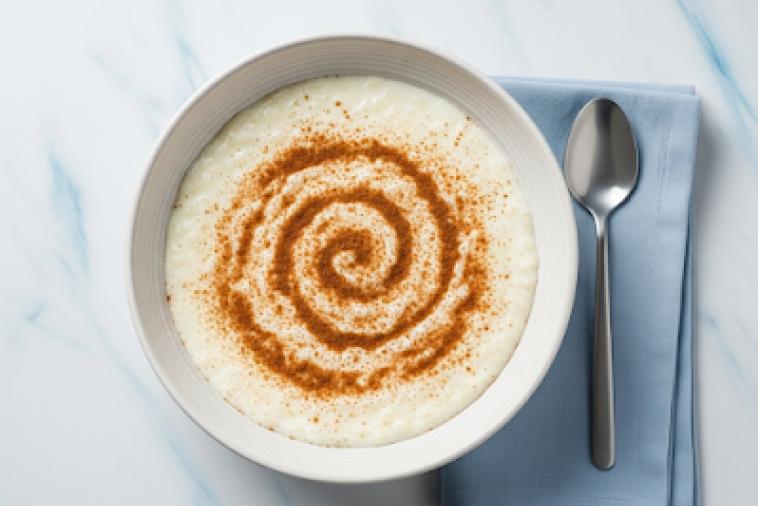 Bowl of rice pudding with a cinnamon swirl ontop