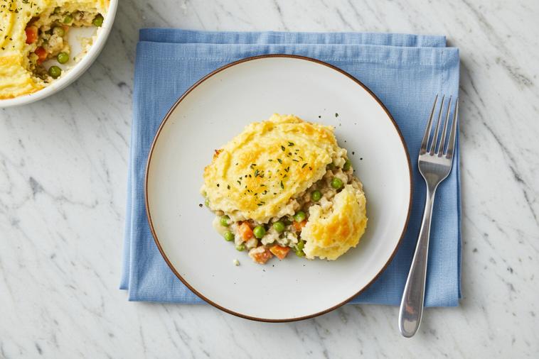 Top-down image of cheesy shepherd’s pie served on a plate