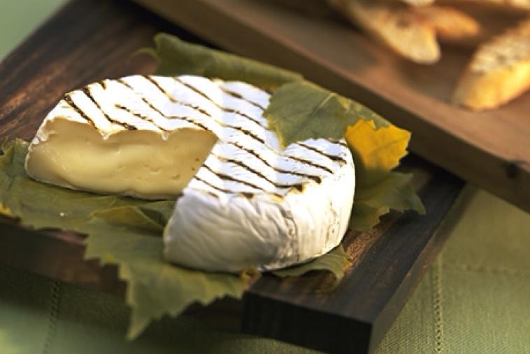 canadian brie wrapped in grape leaves with exotic grain salad