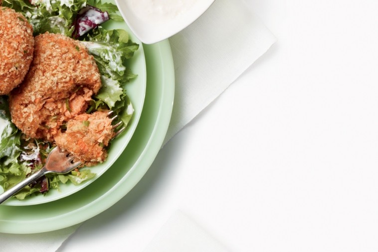 golden crispy salmon cakes on greens