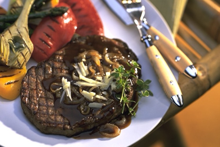 Grilled Rib Eye Steak with Canadian Cheddar and Roasted Onion Sauce