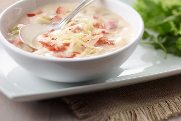 ham and potato soup Warm and inviting bowl of Ham and Potato Soup topped with cheese, ready to comfort and satisfy