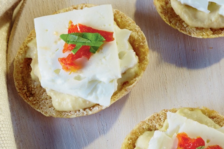 hummus and feta on a cracker