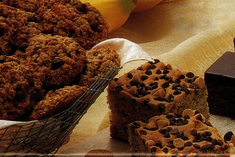 oatmeal chocolate and almond cookies Oatmeal cookies next to squares of chocolate chip loaf