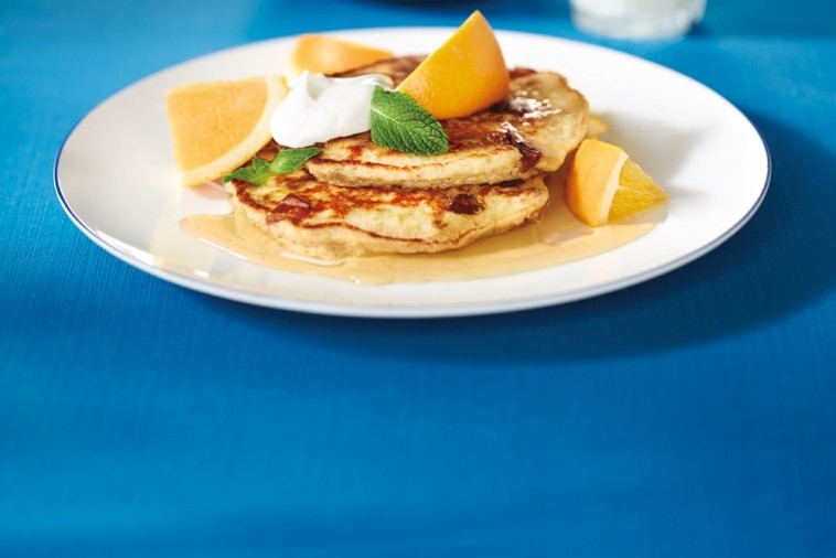oatmeal date pancakes Plate of pancakes covered in syrup and fruit