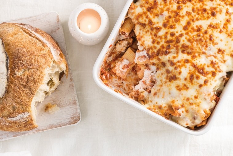 Rigatoni casserole served with a fresh loaf of bread