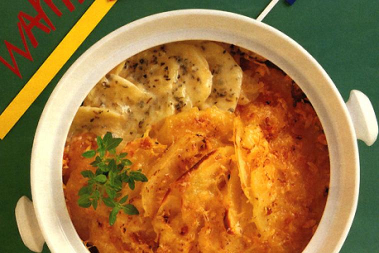 Cheesy herb scalloped potatoes served in a bowl 