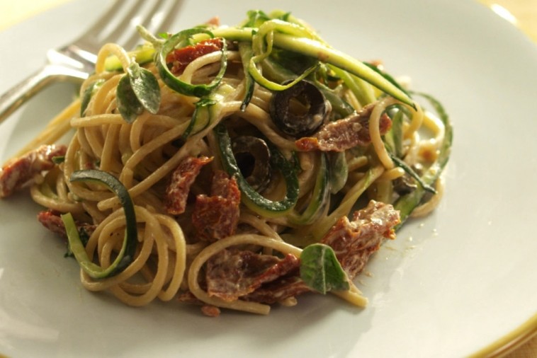 Bowl of spaghetti with creamy yogurt sauce, zucchini, and sundried tomatoes