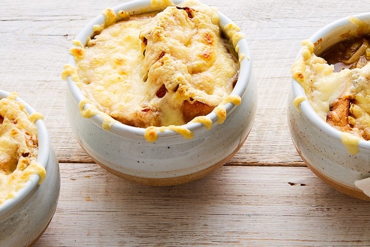 Bowls of french leek soup with swiss cheese