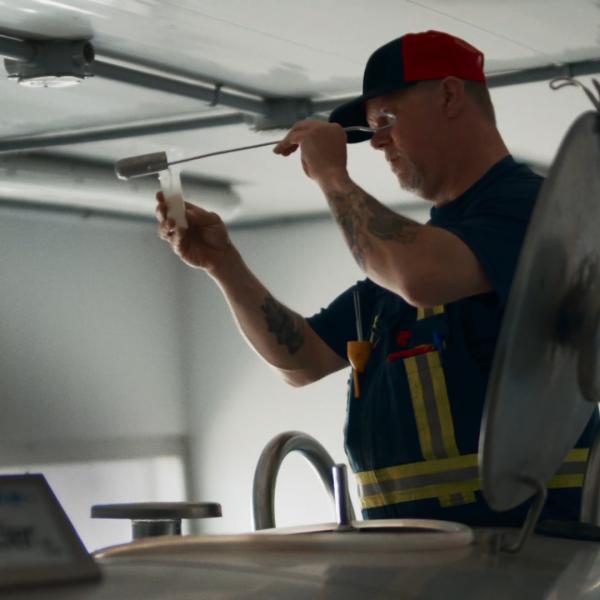Image of a farmer testing milk