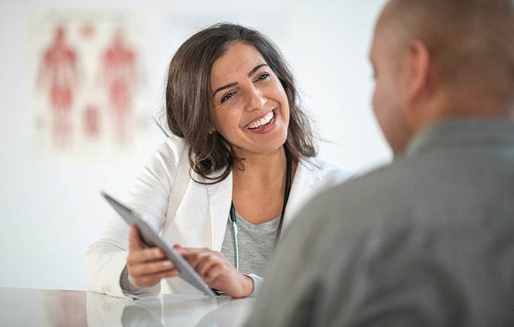 A health professional gives advice to a young man